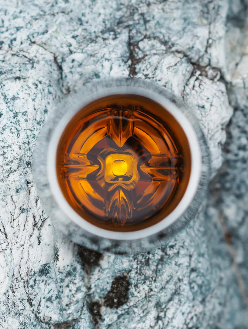 Looking down into the Norlan Steel Tumbler with a burnt orange whiskey inside.