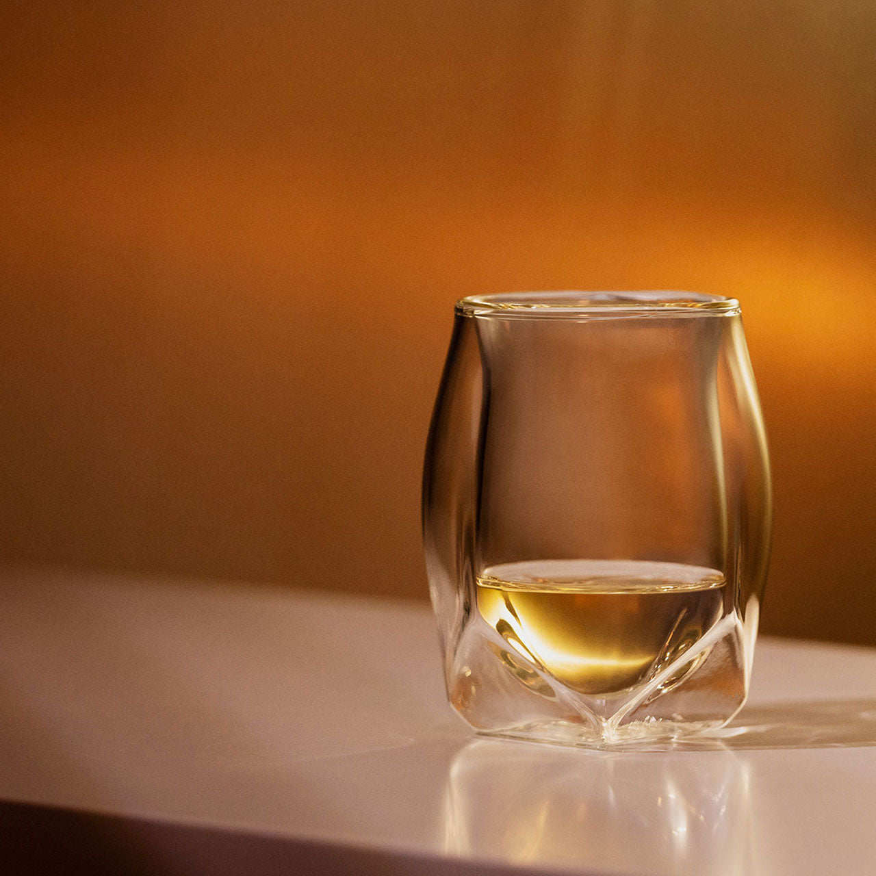 A double-walled whiskey tasting glass